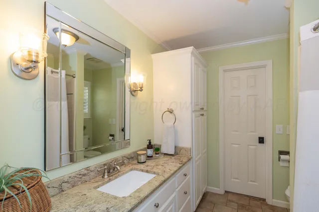 an aerial view of residential house with parking space and trees all around