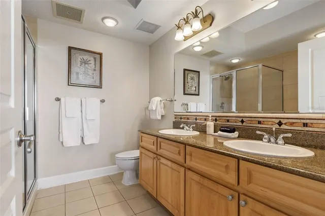 a view of a swimming pool with a table and chairs under an umbrella
