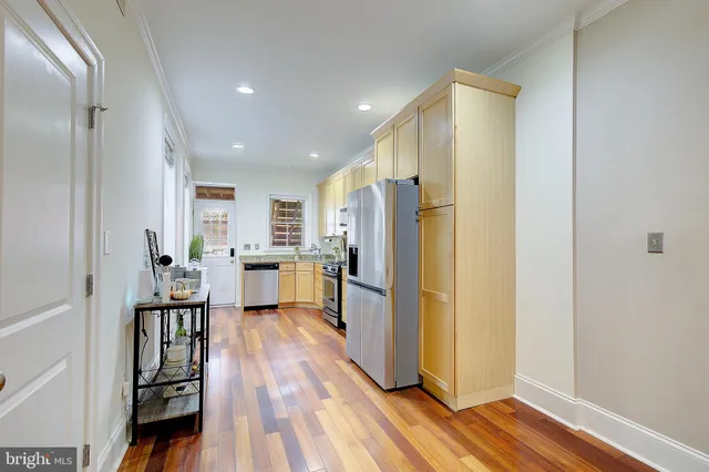 a kitchen with a refrigerator and a sink