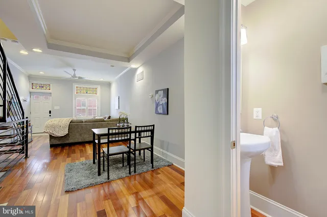 a view of a dining room with furniture and wooden floor