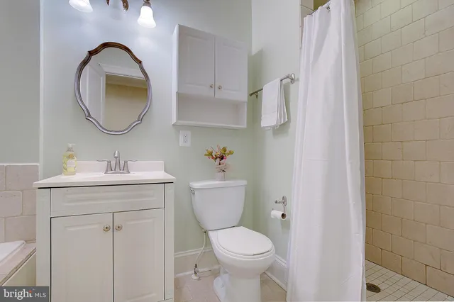 a bathroom with a toilet a sink and a mirror