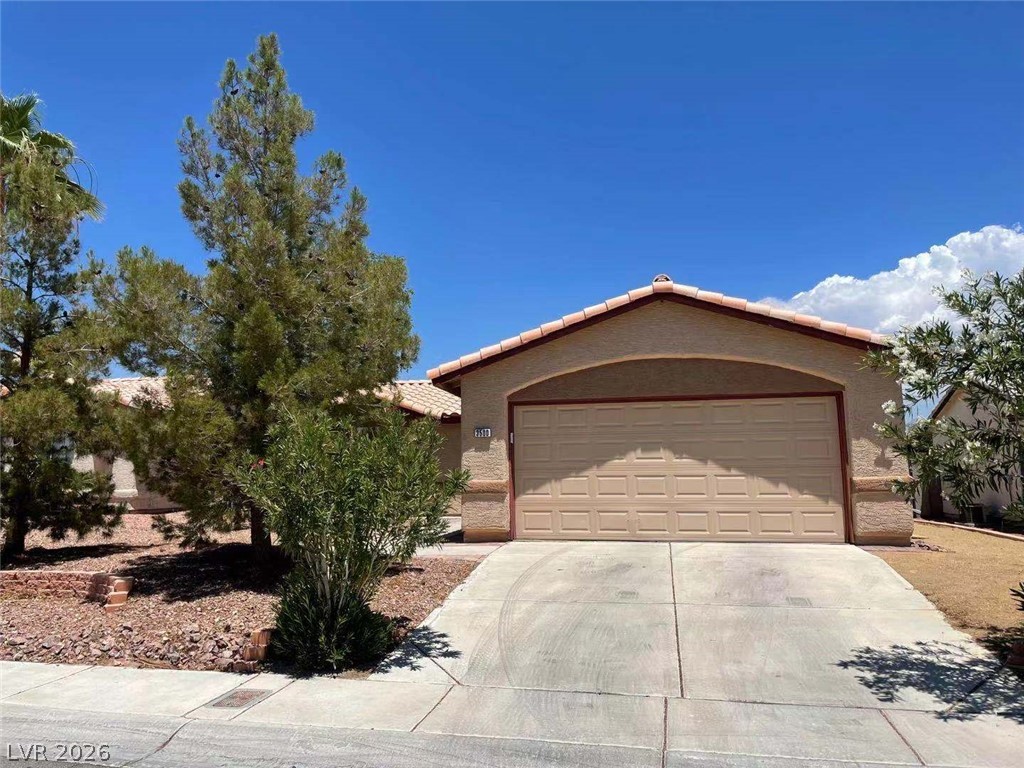 3500 Redwood Ridge Way North Las Vegas, NV 89031 - Photo 1 of 13 A well-maintained concrete driveway leads to the attached garage of this charming single-story home.