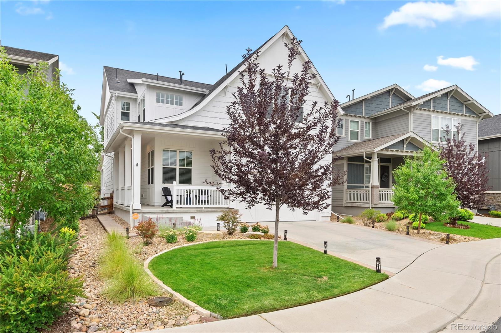 a front view of a house with a garden