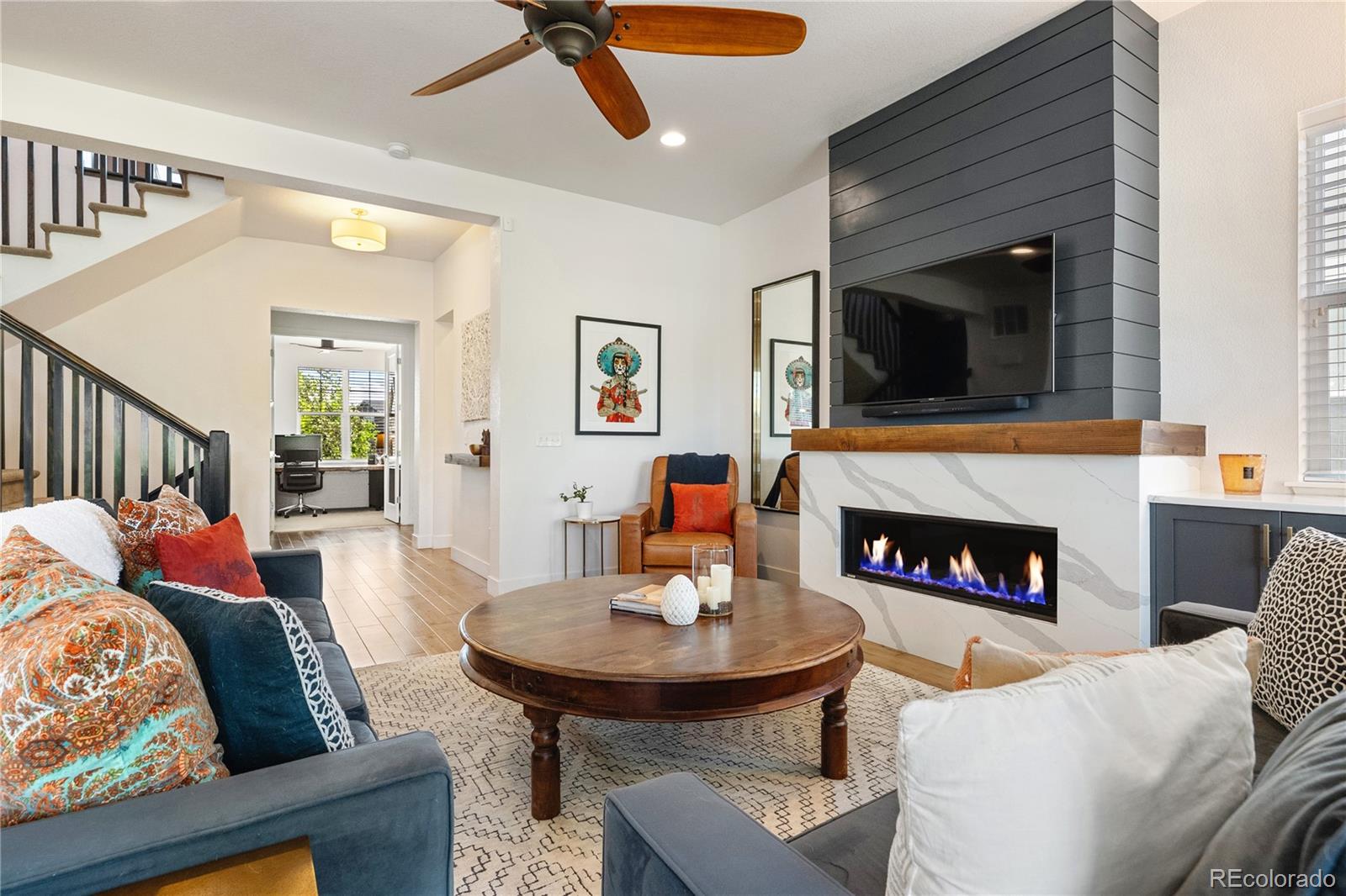 2027 Vallejo Loop Broomfield, CO 80023 - Photo 18 of 50 a living room with furniture and a fireplace