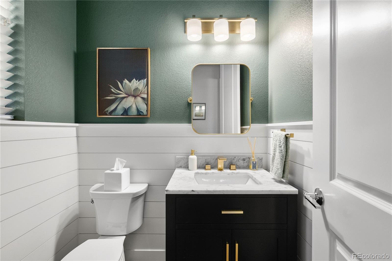 2027 Vallejo Loop Broomfield, CO 80023 - Photo 19 of 50 a bathroom with a toilet sink and mirror