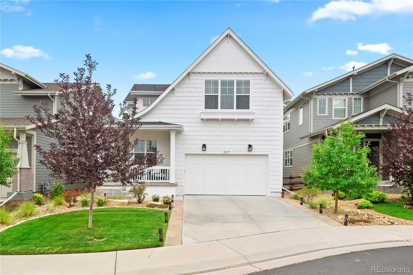 2027 Vallejo Loop Broomfield, CO 80023 - Photo 2 of 50 a view of a white house with a yard and plants