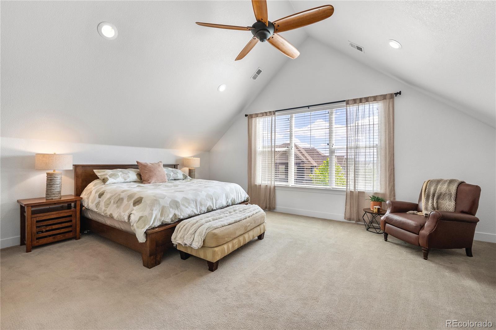2027 Vallejo Loop Broomfield, CO 80023 - Photo 22 of 50 a spacious bedroom with a bed a table and chair