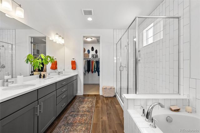 a bathroom with a tub sink and mirror