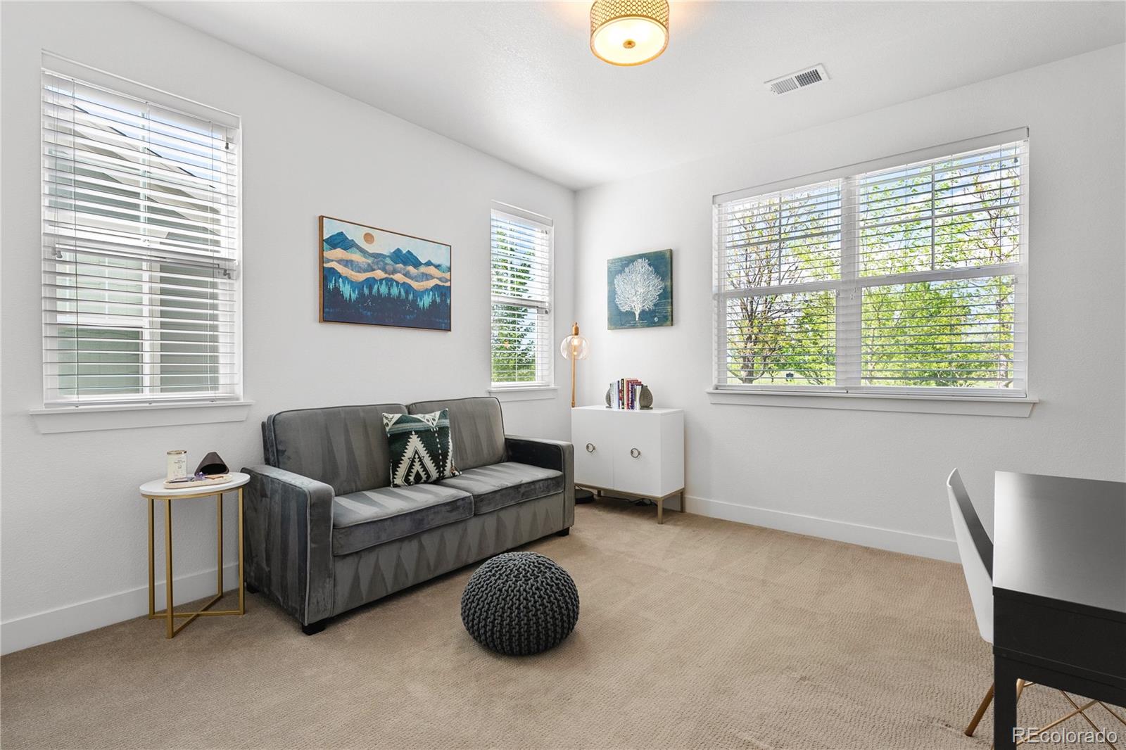 2027 Vallejo Loop Broomfield, CO 80023 - Photo 28 of 50 a living room with furniture and a large window