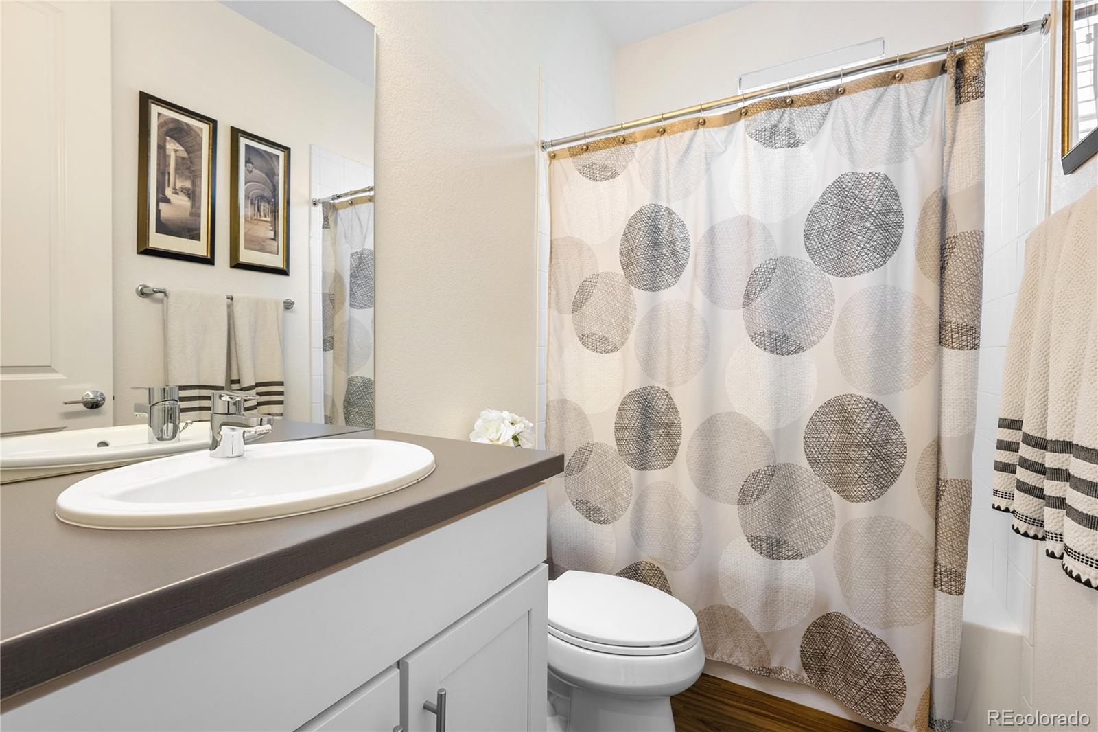 2027 Vallejo Loop Broomfield, CO 80023 - Photo 33 of 50 a bathroom with a sink toilet and shower