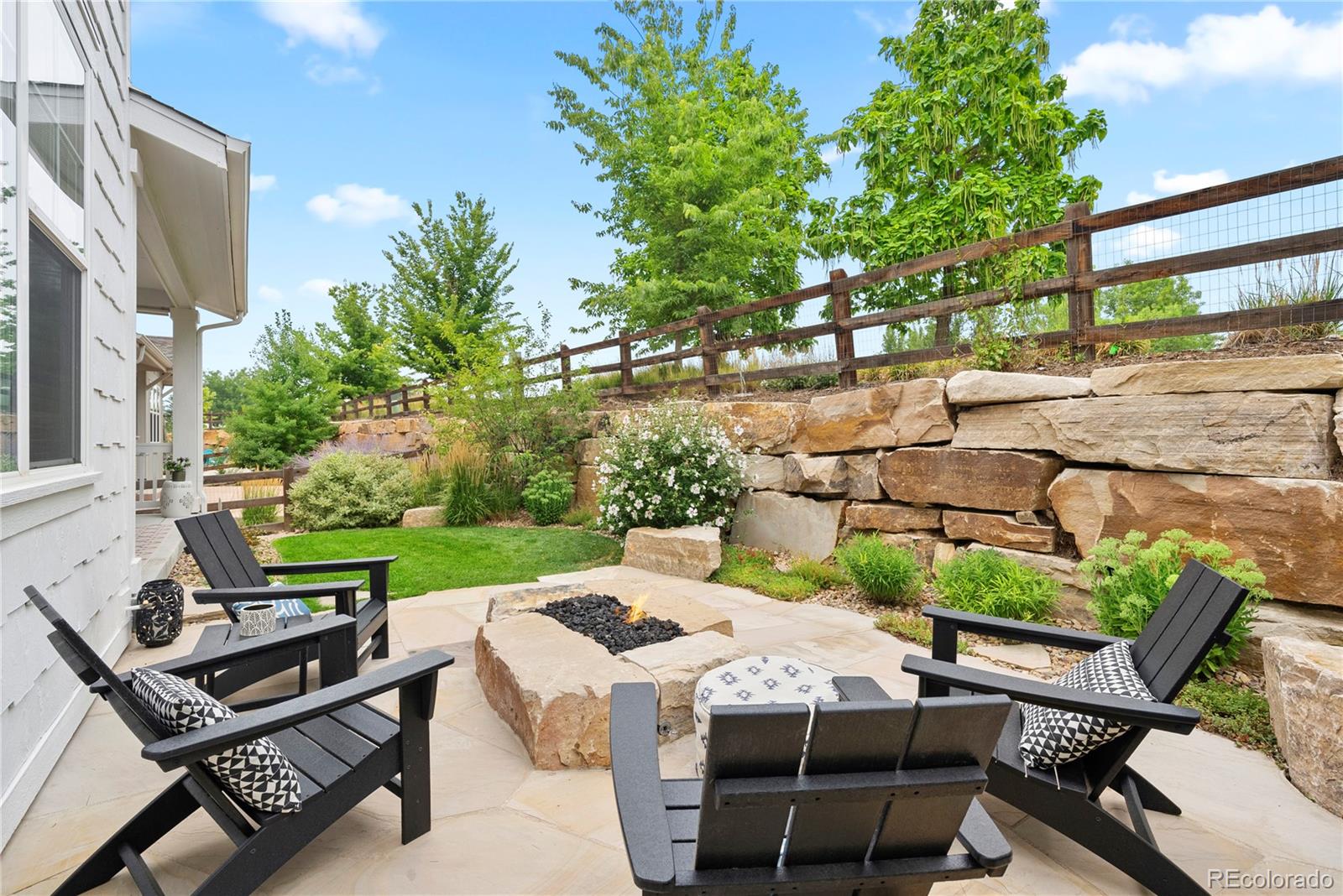 2027 Vallejo Loop Broomfield, CO 80023 - Photo 37 of 50 a view of a patio with table and chairs with wooden floor and fence