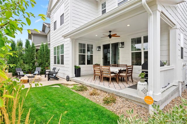 a view of a house with backyard and sitting area