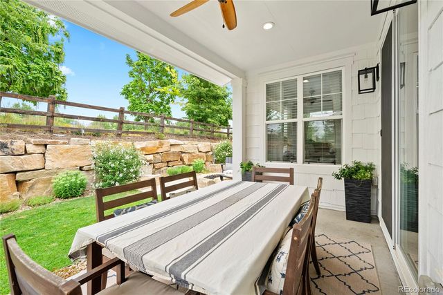 a view of a patio with a table chairs and a backyard