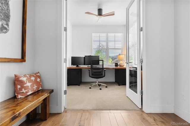 a view of workspace with wooden floor windows