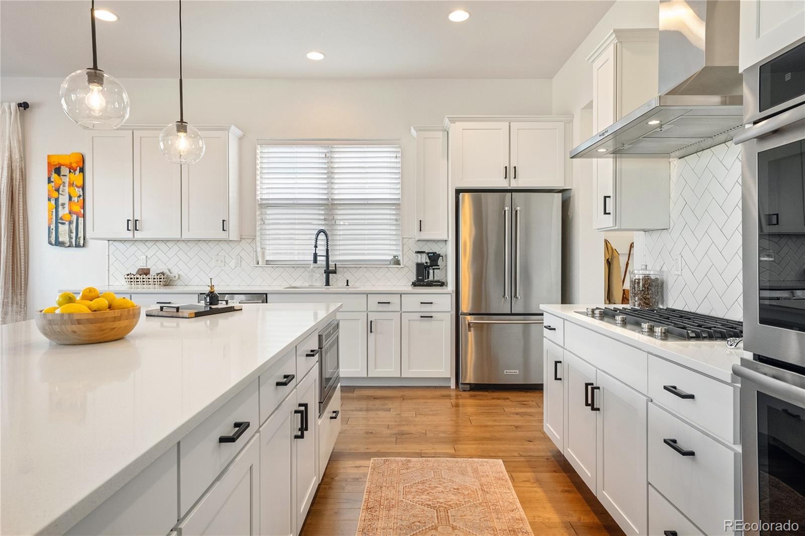 2027 Vallejo Loop Broomfield, CO 80023 - Photo 8 of 50 a kitchen with stainless steel appliances a stove refrigerator a sink and a refrigerator