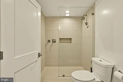 a utility room with dryer washer and a view of living room