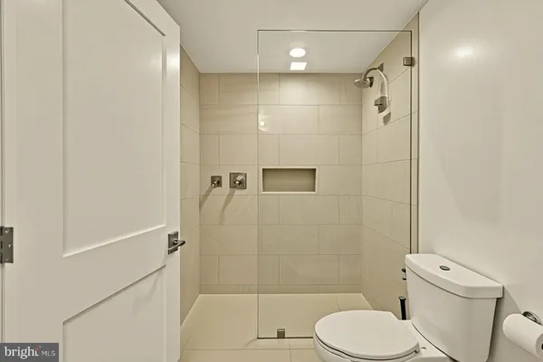 a utility room with dryer washer and a view of living room