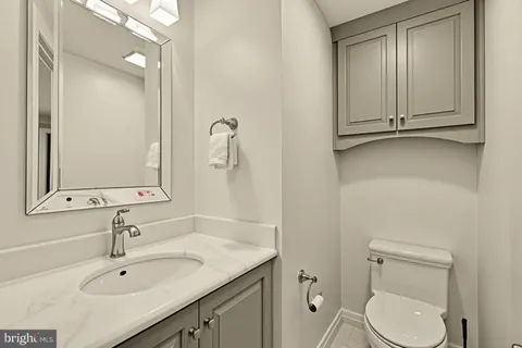 a bathroom with a sink toilet and vanity