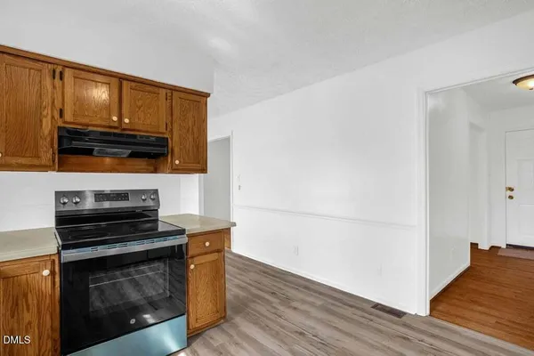 a kitchen with wooden floors and appliances