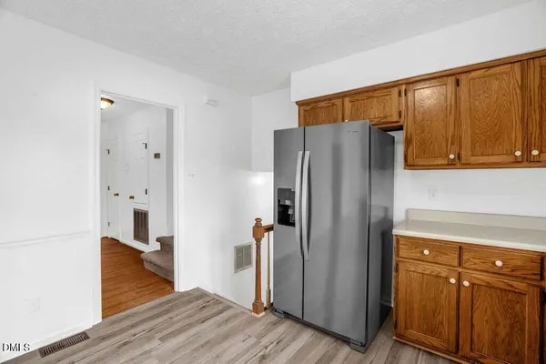a kitchen with stainless steel appliances granite countertop a refrigerator and a sink