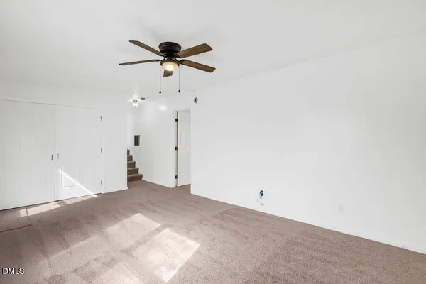 a view of a room with a ceiling fan