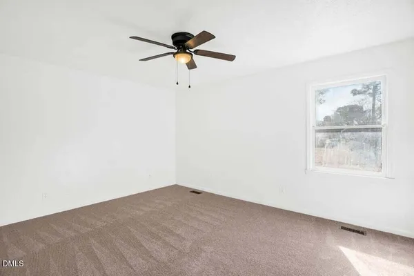 a view of a room with a fan and a window