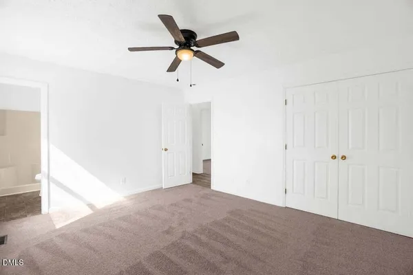 a view of a livingroom with a ceiling fan & a ceiling fan
