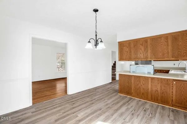 a view of a kitchen with wooden floor and a sink