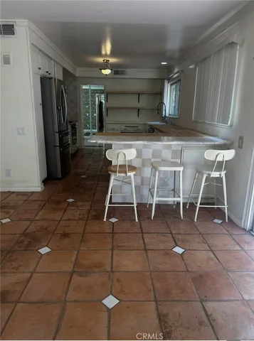 a kitchen with stainless steel appliances and white cabinets