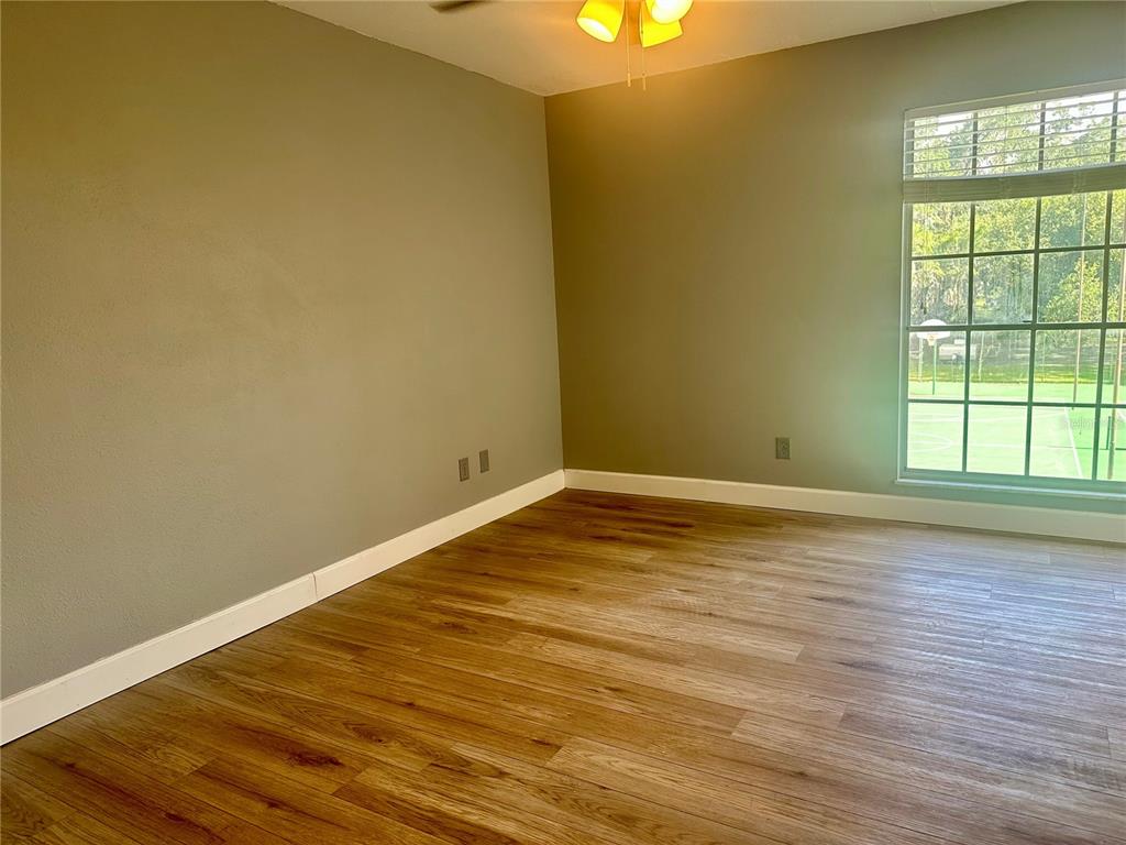 435 Wymore Road, Unit 207 Altamonte Springs, FL 32714 - Photo 6 of 17 a view of empty room with wooden floor and fan