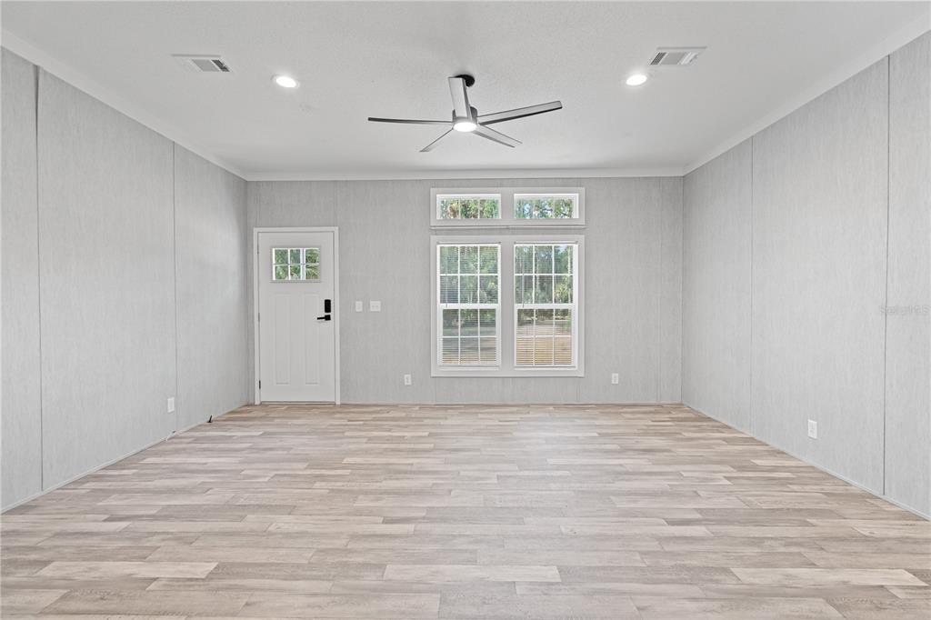 375 Sapp Street Inglis, FL 34449 - Photo 4 of 36 a view of an empty room with a window and a ceiling fan