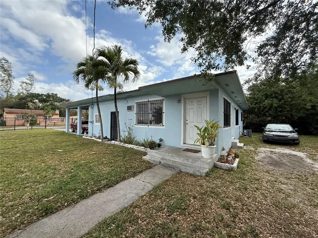 a front view of a house with a yard garage and outdoor seating