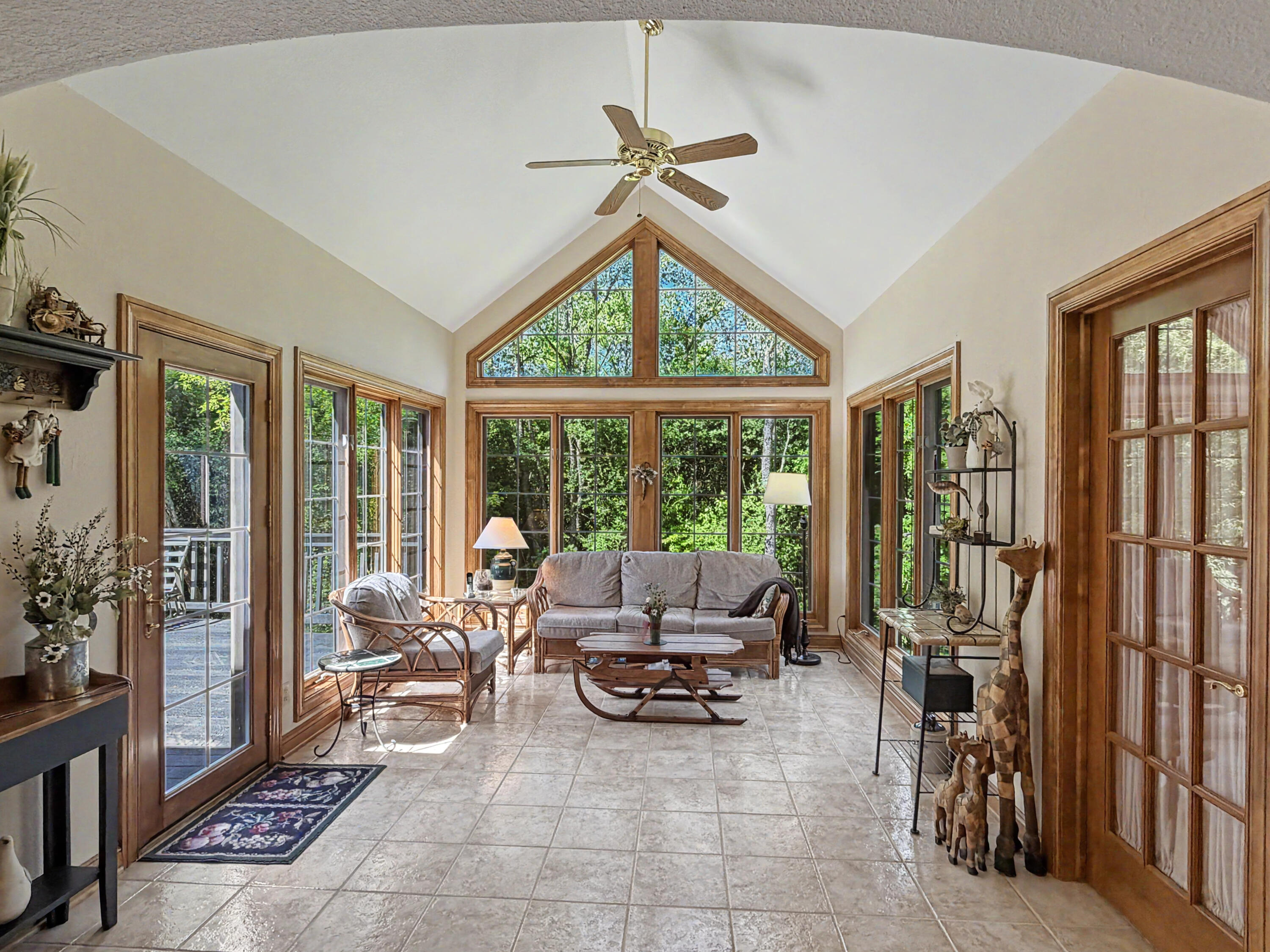 W291-s5245 Ridgefield Road Waukesha, WI 53189 - Photo 7 of 44 Flowing seamlessly from the kitchen, this light-filled sunroom offers a vaulted ceiling, walls of windows, serene wooded views, and direct access to the 32X 16 composite deck!