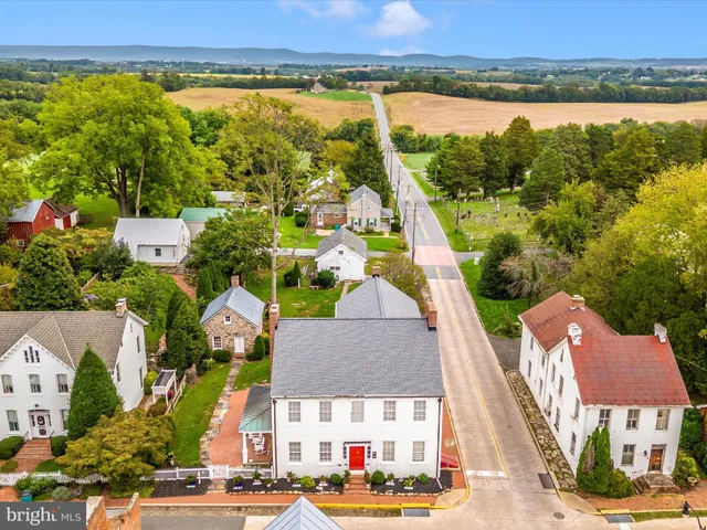 an aerial view of residential houses with outdoor space and swimming pool