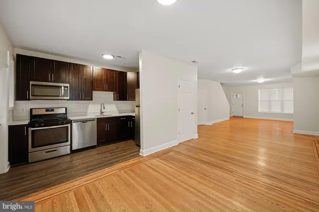 a large kitchen with a stove a sink and a refrigerator
