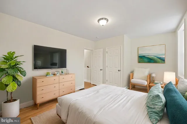 a bedroom with a bed and a flat screen tv