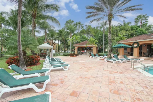 a view of a house with backyard porch and sitting area