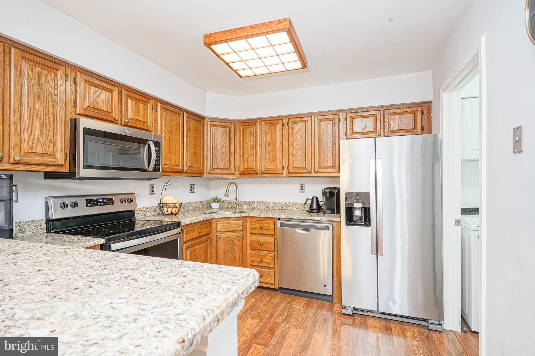 5 Kent Place Sewell, NJ 08080 - Photo 7 of 28 a kitchen with stainless steel appliances granite countertop a refrigerator stove microwave and sink