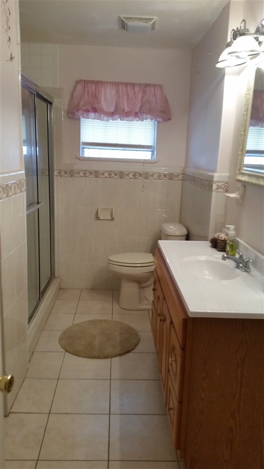 2619 Mier Street Laredo, TX 78043 - Photo 6 of 10 a bathroom with a sink a toilet and a mirror