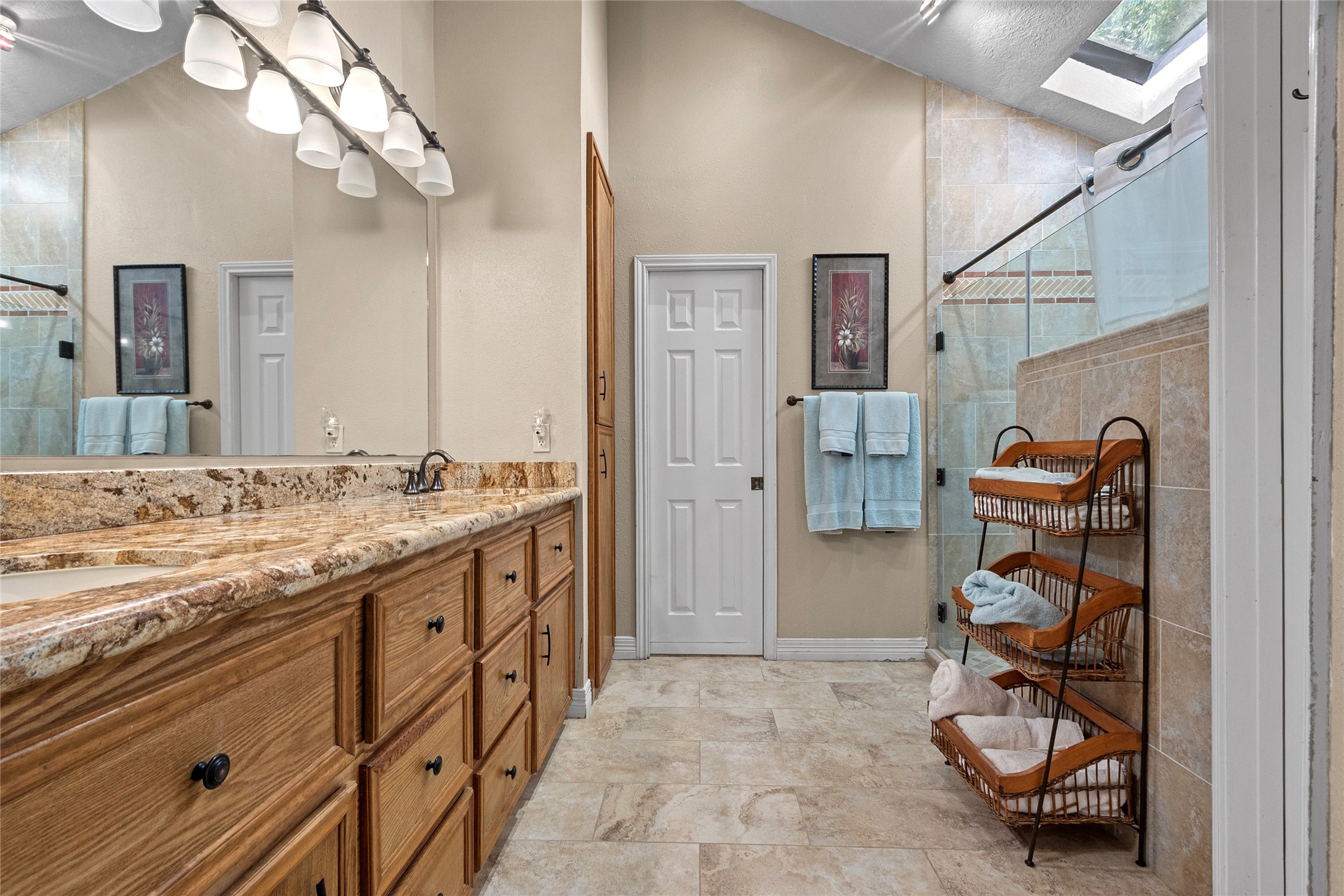 89 Heatley Street Trinity, TX 75862 - Photo 27 of 49 a bathroom with a granite countertop sink a mirror and shower