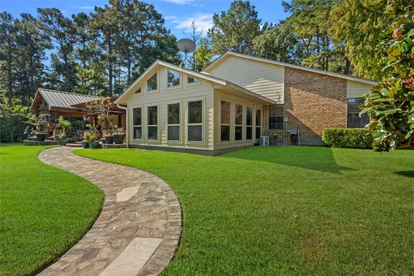 a front view of house with yard and green space