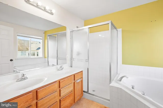 a bathroom with a tub sink and mirror