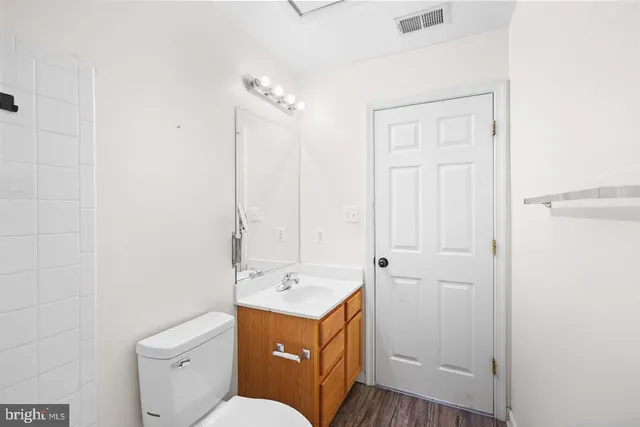 a view of bathroom with a sink a toilet and a mirror