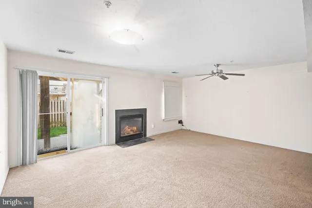 a view of empty room with a fireplace