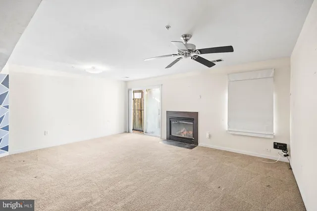 a view of empty room with fireplace