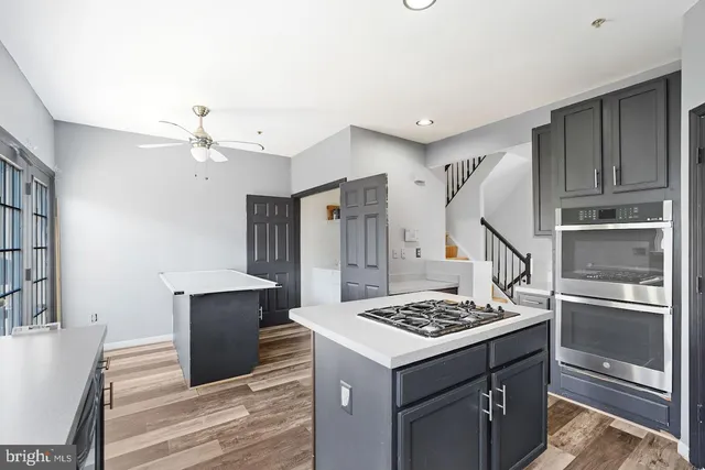 a kitchen with a refrigerator and a stove