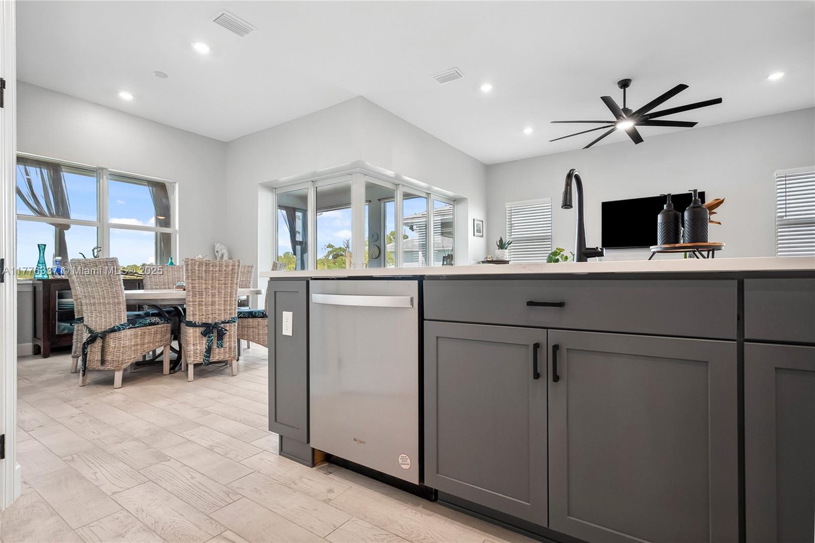 9734 Southwest Meridian Way Stuart, FL 34997 - Photo 11 of 48 a kitchen with counter top space cabinets and stainless steel appliances