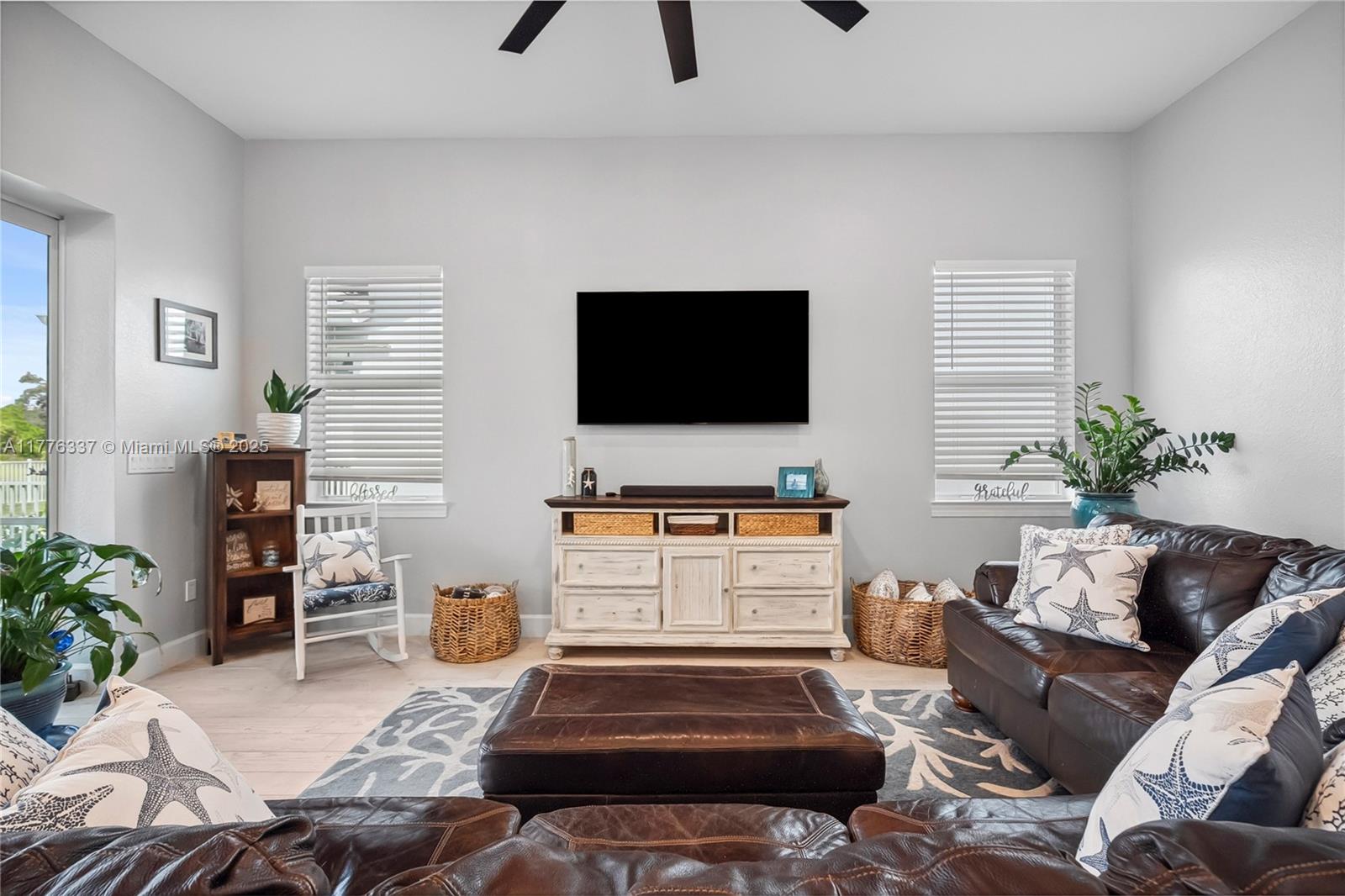 9734 Southwest Meridian Way Stuart, FL 34997 - Photo 15 of 48 a living room with furniture and a flat screen tv