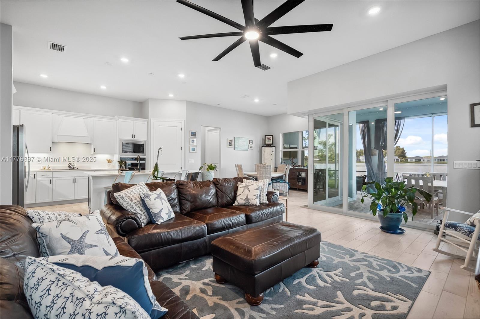 9734 Southwest Meridian Way Stuart, FL 34997 - Photo 16 of 48 a living room with furniture and a view of kitchen