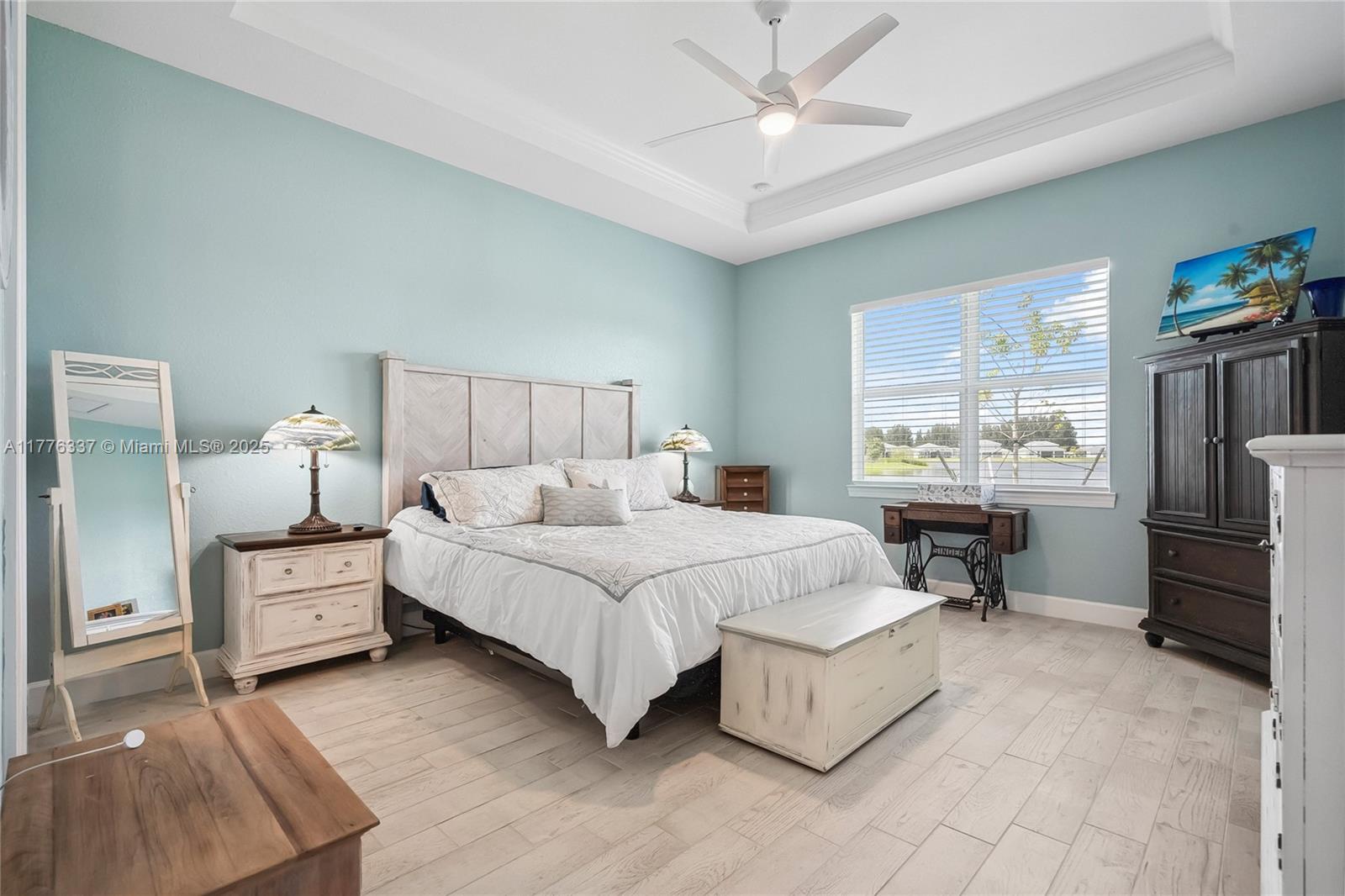 9734 Southwest Meridian Way Stuart, FL 34997 - Photo 18 of 48 a bedroom with a large bed and a window